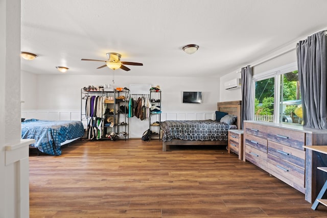 3689 Suzanne Way, Redding, CA 96002 - bedroom with an AC wall unit, wood finished floors, and a wainscoted wall