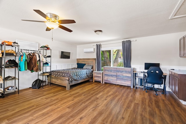 3689 Suzanne Way, Redding, CA 96002 - bedroom with an AC wall unit, wood finished floors, wainscoting, a desk, and ceiling fan