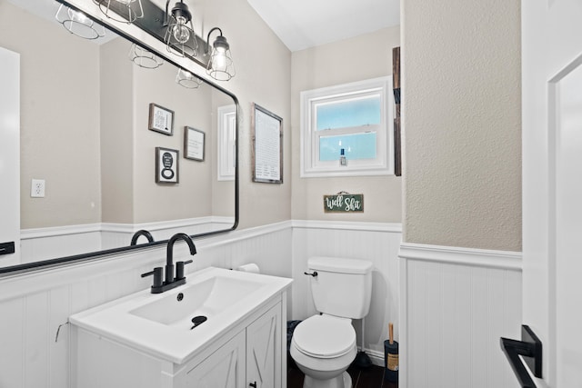 3689 Suzanne Way, Redding, CA 96002 - bathroom featuring a wainscoted wall, toilet, and vanity