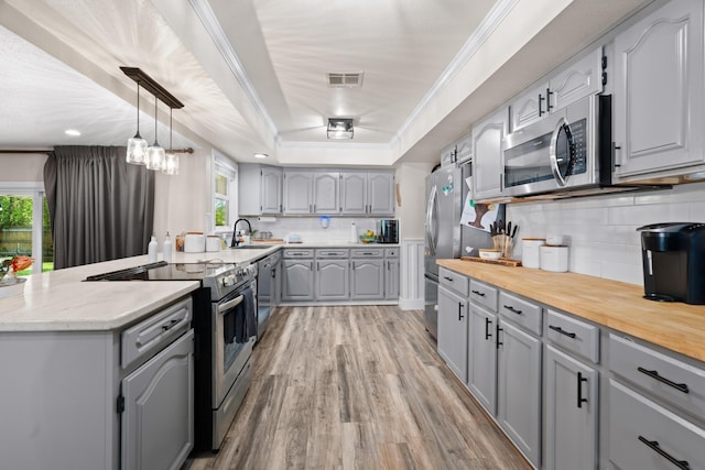 3689 Suzanne Way, Redding, CA 96002 - kitchen with appliances with stainless steel finishes, gray cabinetry, healthy amount of natural light, and ornamental molding