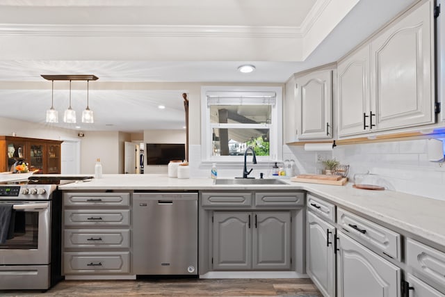 3689 Suzanne Way, Redding, CA 96002 - kitchen with stainless steel appliances, a sink, gray cabinets, ornamental molding, and wood finished floors