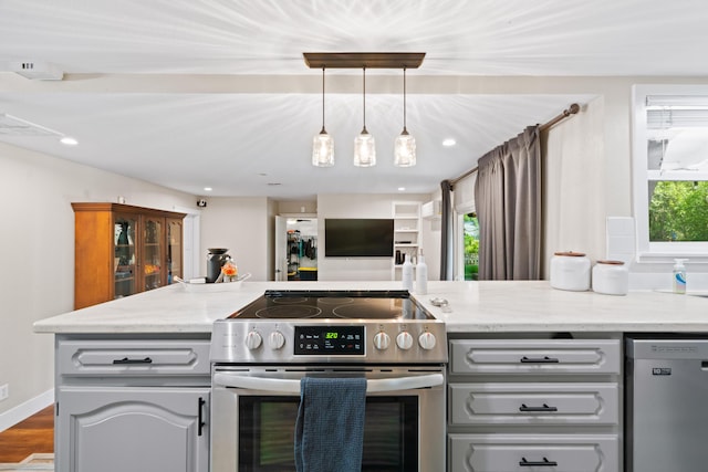 3689 Suzanne Way, Redding, CA 96002 - kitchen with appliances with stainless steel finishes, light stone countertops, hanging light fixtures, recessed lighting, and wood finished floors