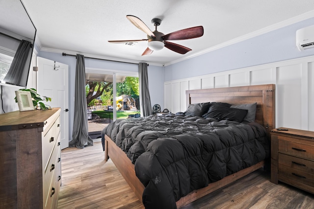 3689 Suzanne Way, Redding, CA 96002 - bedroom featuring access to exterior, crown molding, light wood-type flooring, a ceiling fan, and a wall unit AC