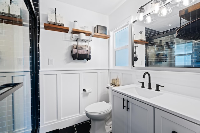3689 Suzanne Way, Redding, CA 96002 - bathroom with toilet, a decorative wall, vanity, a tile shower, and a wainscoted wall