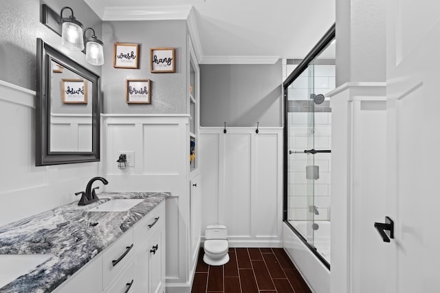 3689 Suzanne Way, Redding, CA 96002 - bathroom featuring a decorative wall, ornamental molding, bath / shower combo with glass door, double vanity, and a wainscoted wall