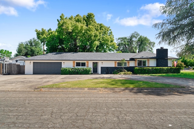 3689 Suzanne Way, Redding, CA 96002 - single story home featuring concrete driveway, an attached garage, fence, and a chimney