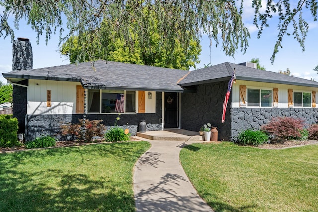 3689 Suzanne Way, Redding, CA 96002 - ranch-style home featuring stone siding, a chimney, a front lawn, a porch, and roof with shingles