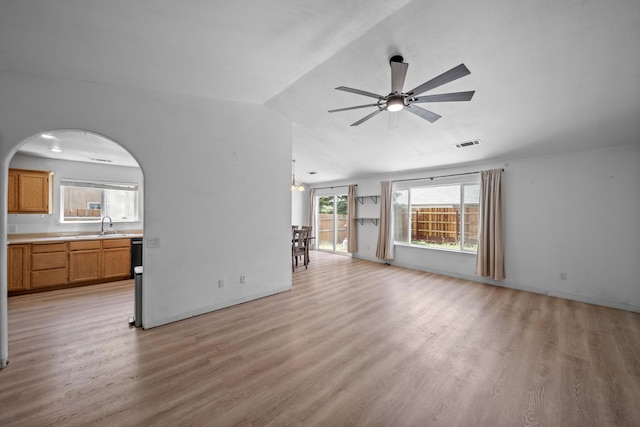 1706 Stanton Dr, Shasta Lake, CA 96019 - unfurnished living room with light wood-style floors, a ceiling fan, lofted ceiling, and arched walkways
