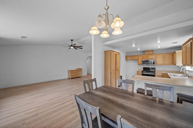 1706 Stanton Dr, Shasta Lake, CA 96019 - dining room with light wood-style flooring, ceiling fan, a chandelier, arched walkways, and lofted ceiling