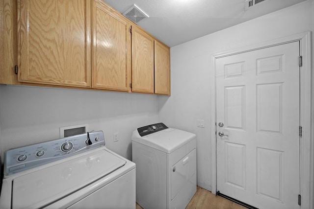 1706 Stanton Dr, Shasta Lake, CA 96019 - laundry area featuring cabinet space, independent washer and dryer, and light wood-type flooring