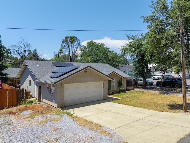 1706 Stanton Dr, Shasta Lake, CA 96019 - ranch-style home with an attached garage, stucco siding, concrete driveway, a shingled roof, and solar panels