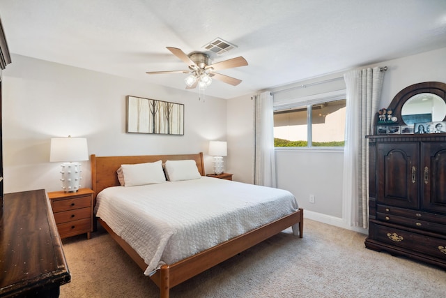 bedroom featuring light colored carpet, baseboards, and a ceiling fan