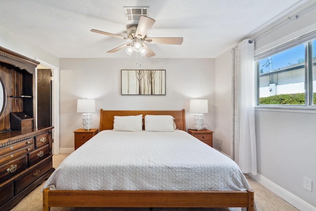 bedroom featuring light carpet, baseboards, and ceiling fan