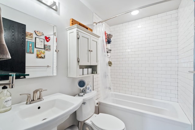 bathroom featuring a sink, toilet, and shower / bath combo