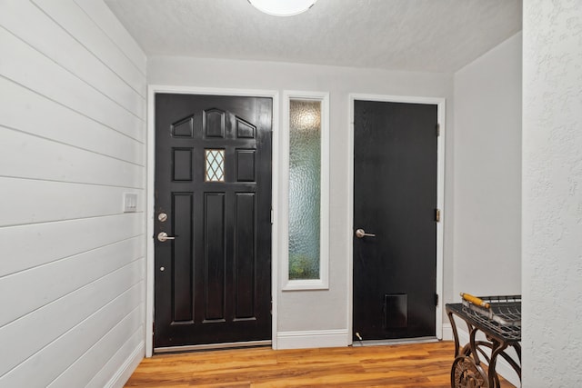 entrance foyer with light wood-style floors and baseboards
