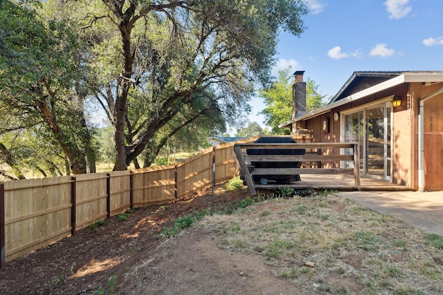 view of yard with a wooden deck and fence