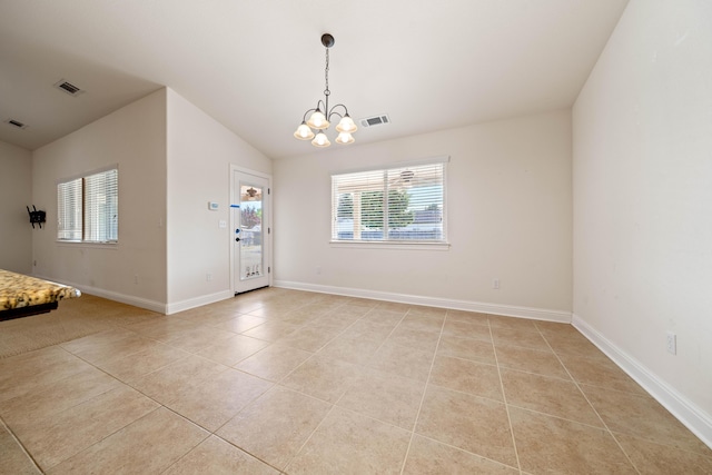 6552 Capitola Pl, Redding, CA 96001 - spare room featuring light tile patterned flooring, a chandelier, lofted ceiling, and baseboards