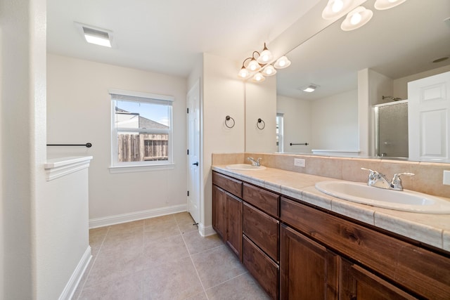 6552 Capitola Pl, Redding, CA 96001 - full bathroom with baseboards, double vanity, a stall shower, and tile patterned flooring