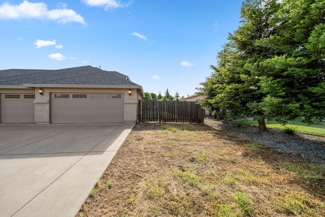 6552 Capitola Pl, Redding, CA 96001 - view of yard featuring driveway and a garage