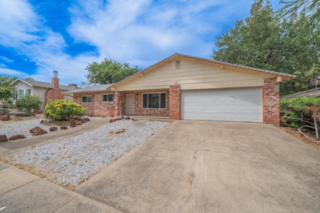 ranch-style home with brick siding, a garage, and driveway
