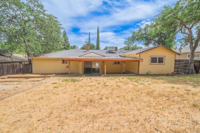rear view of property with a chimney