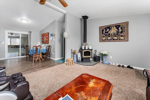 16605 Lassen Ave, Anderson, CA 96007 - living area featuring a wood stove, ceiling fan, baseboards, lofted ceiling, and wood finished floors