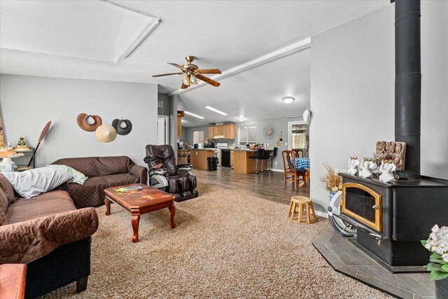 16605 Lassen Ave, Anderson, CA 96007 - living room with a wood stove, vaulted ceiling, ceiling fan, and light wood finished floors