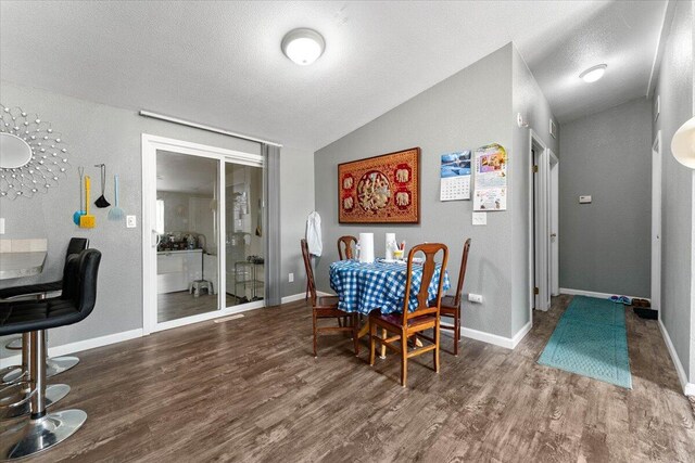 16605 Lassen Ave, Anderson, CA 96007 - dining room with lofted ceiling, wood finished floors, baseboards, and a textured ceiling