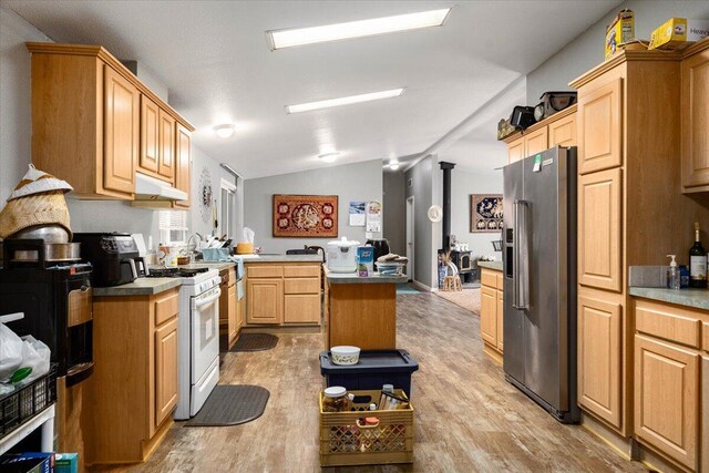 16605 Lassen Ave, Anderson, CA 96007 - kitchen with high end refrigerator, white gas range oven, light wood-style flooring, under cabinet range hood, and vaulted ceiling