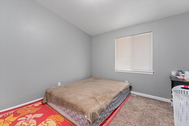 16605 Lassen Ave, Anderson, CA 96007 - carpeted bedroom featuring vaulted ceiling and baseboards
