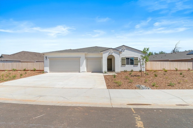 5555 Feathers Ave, Redding, CA 96002 - single story home with an attached garage, fence, stucco siding, and concrete driveway