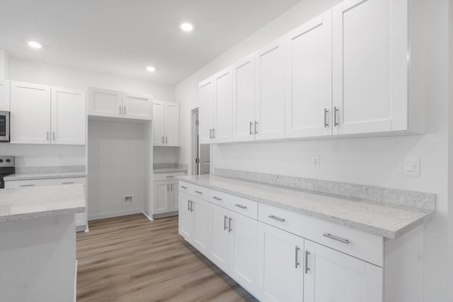 5555 Feathers Ave, Redding, CA 96002 - kitchen with white cabinetry, stainless steel appliances, recessed lighting, light wood-type flooring, and light stone countertops