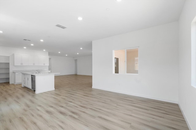 5555 Feathers Ave, Redding, CA 96002 - unfurnished living room featuring recessed lighting, light wood finished floors, baseboards, and a sink