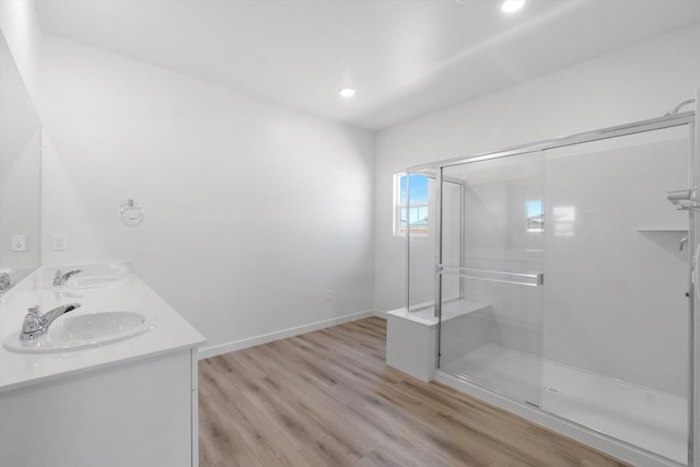 5555 Feathers Ave, Redding, CA 96002 - full bath with wood finished floors, a stall shower, baseboards, double vanity, and recessed lighting