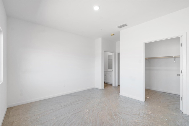 5555 Feathers Ave, Redding, CA 96002 - unfurnished bedroom with carpet floors, a walk in closet, baseboards, a closet, and connected bathroom