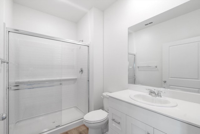 5555 Feathers Ave, Redding, CA 96002 - full bathroom featuring toilet, a stall shower, vanity, and wood finished floors