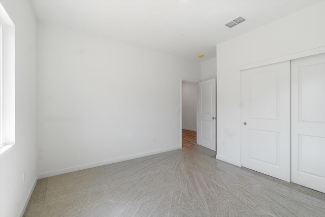 5555 Feathers Ave, Redding, CA 96002 - unfurnished bedroom with light carpet, a closet, and baseboards