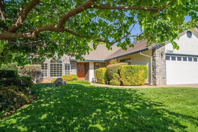 1366 Carla Cir, Redding, CA 96003 - view of front of property with stone siding, a front yard, a garage, and stucco siding