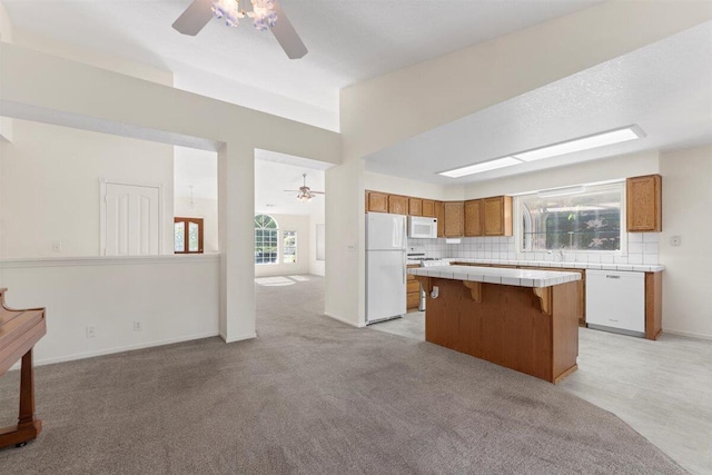 1366 Carla Cir, Redding, CA 96003 - kitchen featuring ceiling fan, white appliances, tile countertops, a center island, and brown cabinets