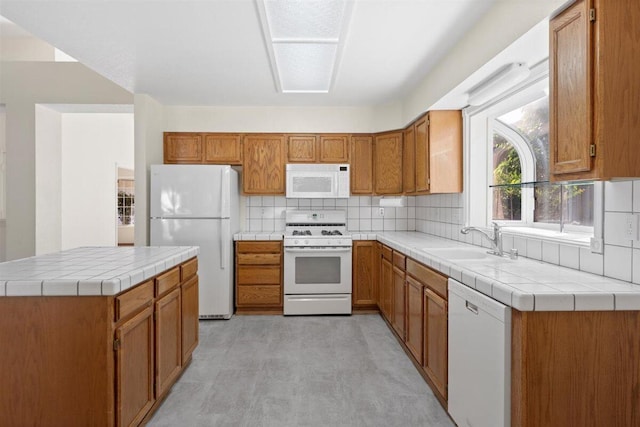 1366 Carla Cir, Redding, CA 96003 - kitchen featuring white appliances, a sink, brown cabinets, tasteful backsplash, and a center island