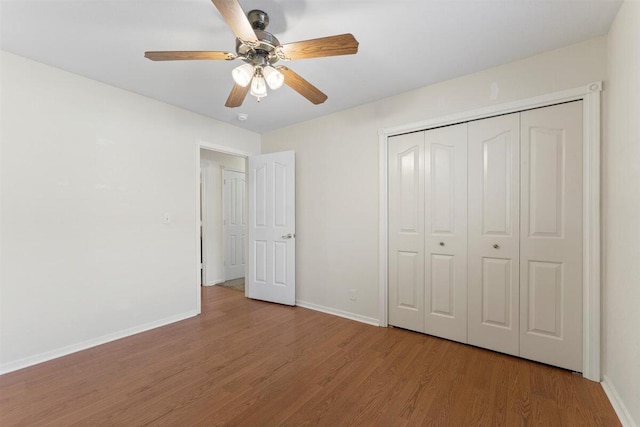 1366 Carla Cir, Redding, CA 96003 - unfurnished bedroom with wood finished floors, baseboards, a closet, and ceiling fan
