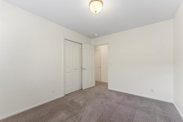 1366 Carla Cir, Redding, CA 96003 - unfurnished bedroom with carpet flooring, baseboards, and a closet