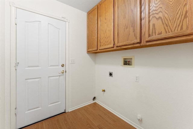 1366 Carla Cir, Redding, CA 96003 - laundry area featuring hookup for a washing machine, baseboards, wood finished floors, electric dryer hookup, and cabinet space