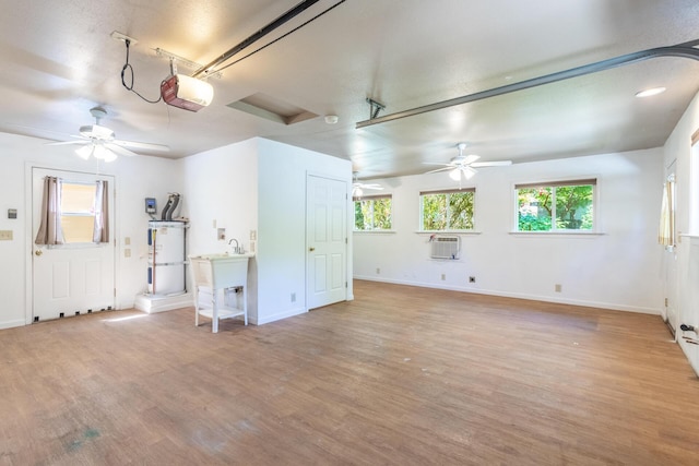 1556 Santa Fe Ave, Redding, CA 96003 - garage with a garage door opener, a ceiling fan, baseboards, secured water heater, and a wall mounted air conditioner