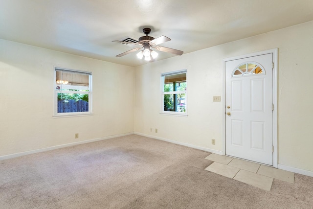 1556 Santa Fe Ave, Redding, CA 96003 - foyer entrance featuring light colored carpet, plenty of natural light, a ceiling fan, and baseboards