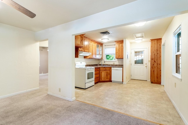1556 Santa Fe Ave, Redding, CA 96003 - kitchen featuring white appliances, under cabinet range hood, a sink, and baseboards