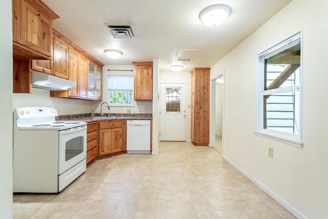 1556 Santa Fe Ave, Redding, CA 96003 - kitchen featuring white appliances, under cabinet range hood, a sink, baseboards, and dark countertops