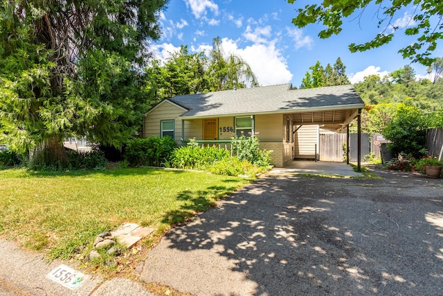 1556 Santa Fe Ave, Redding, CA 96003 - single story home featuring asphalt driveway, a carport, and roof with shingles