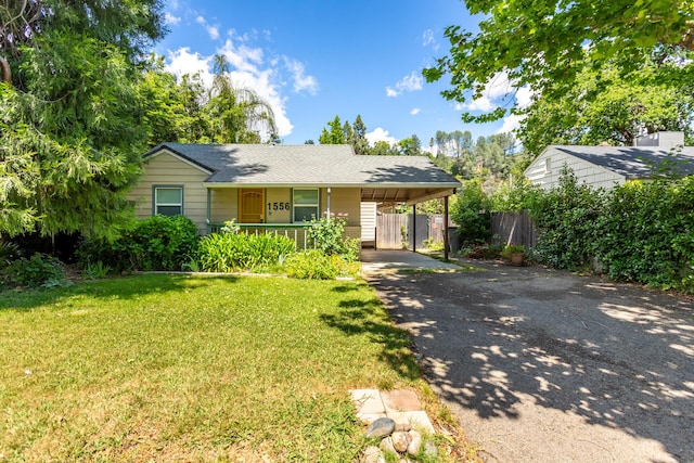 1556 Santa Fe Ave, Redding, CA 96003 - view of front facade with asphalt driveway, covered porch, a carport, and a shingled roof