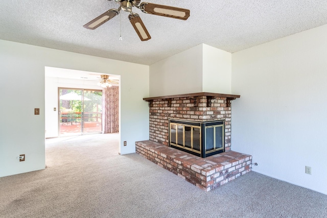 unfurnished living room with carpet flooring, ceiling fan, a textured ceiling, and a fireplace